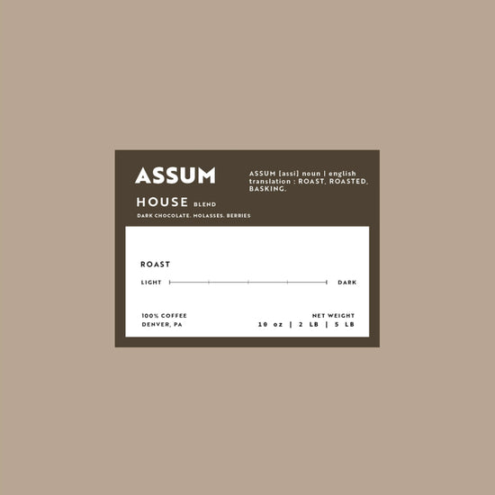 Assum coffee label on a beige background
House blend that has notes of Dark Chocolate, Molasses, and Berries.