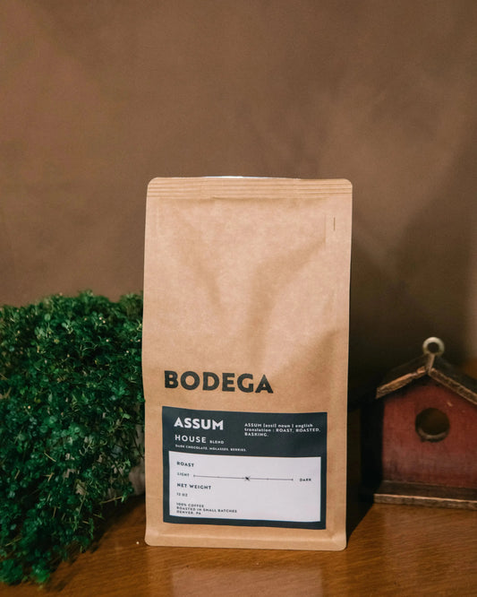 Bodega coffee bag on a wooden surface with a blurred background - Bodega Coffee Roasters