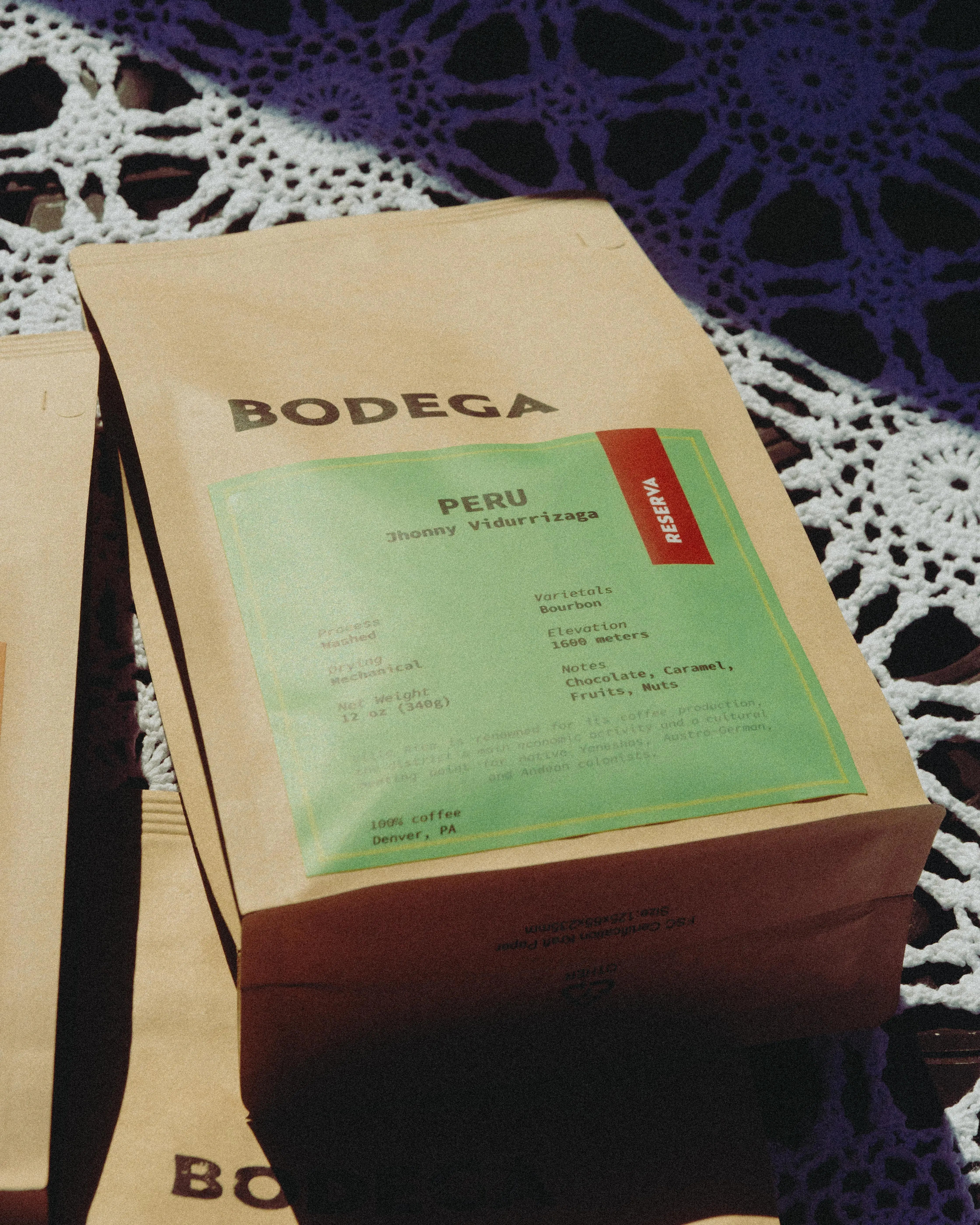 A bag of Peru coffee from Bodega Coffee Roasters, featuring minimalist packaging with origin details, set against a natural backdrop. - Bodega Coffee Roasters