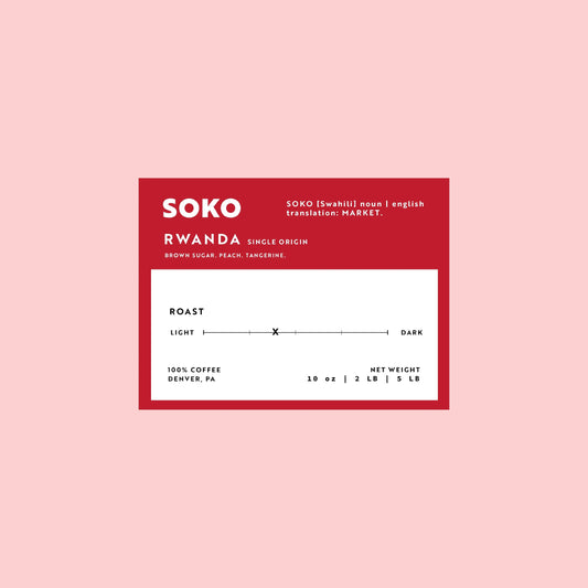 Label of Soko single origin. Red label on a pink background. Rwanda single origin with notes of brown sugar, peach, and tangerine.